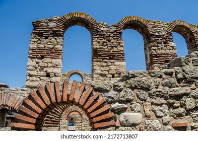 The ancient city of Nessebar fragments of ruins. Antique masonry of red brick.