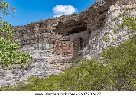 Ancient cliff dwellings built into limestone cliffs in Arizona. Stunning red rock architecture, scenic canyon views, and historic cultural heritage captured in clear desert light