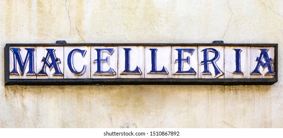 An Ancient Craft Sign Of An Italian Butcher Shop. Ceramic Tiles Inserted In A Metal Structure, Compose The Word 