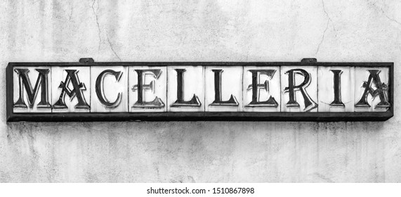 An Ancient Craft Sign Of An Italian Butcher Shop. Ceramic Tiles Inserted In A Metal Structure, Compose The Word 