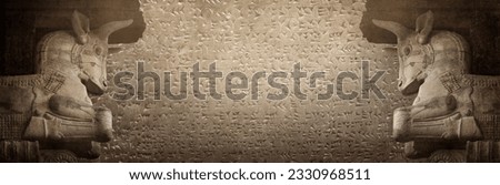 Ancient cuneiform Sumerian and bull statue, a mythical Assyrian deity. Historical background on the theme of civilizations of Assyria, Mesopotamia, Babylon, interfluve, Sumerian.