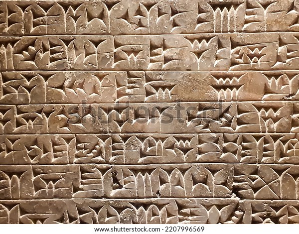Ancient cuneiform\
writing script on the\
wall