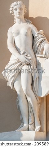 Ancient decayed statue of a sensual Renaissance Era woman in the central city park of Potsdam, a German town of statues and sculptures, Germany, details, closeup