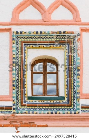 Ancient decorated wall with arched window, background photo texture. Valday Iversky Monastery, Russia