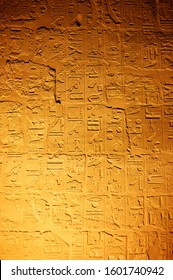 Ancient Egyptian Hieroglyphics Lit In Dramatic Relief For A Full Frame Background