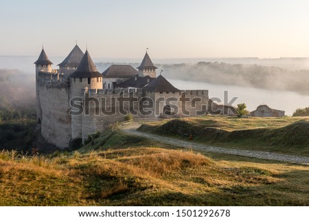 Ancient fortress in Khotyn in morning sun with mist, West Ukraine. Majestic fortification on the banks of the Dniester River, one of the most famous and largest castles in Ukraine.