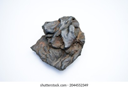 An ancient fragment of brown iron ore on a white isolate.Mining operations. - Shutterstock ID 2044552349