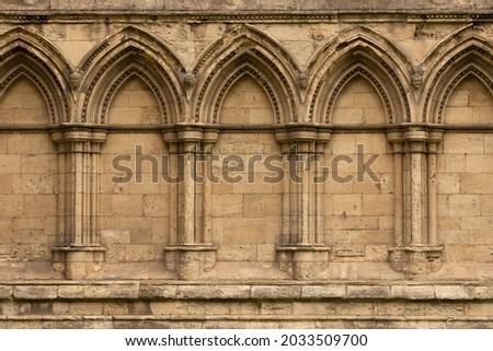 Ancient gothic stone wall with arches and columns in York, England, UK