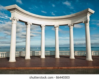 Ancient Greek columns against a blue sky and sea