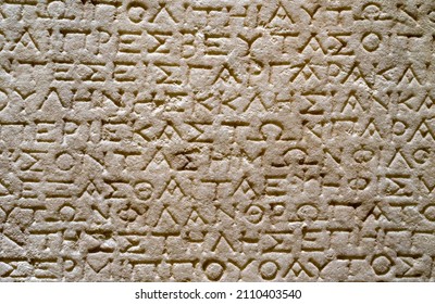 Ancient Greek Cuneiform On A Stone Tablet.