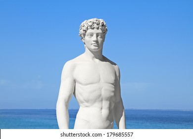 Ancient Greek Statue Of A Young Athlete By The Sea