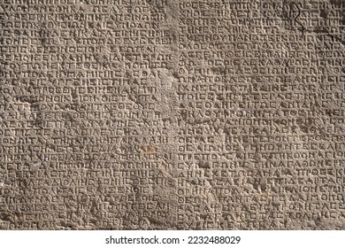 Ancient greek writings on a rock. Historic Arsameia ruins in Eastern Turkey. Ancient greek inscriptions on the wall of archeological ruins close-up. Archeological concept background - Shutterstock ID 2232488029