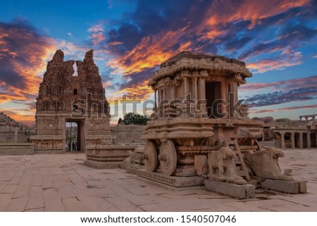 Ancient Hampi Monument Stone Chariot in the the Vittala Temple Complex with dramatic skies during sunset in Unesco Heritage Hampi town Karnataka