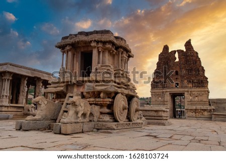 Ancient Hampi Monument Stone Chariot in the the Vittala Temple Complex with dramatic sky during sunset in Unesco Heritage Hampi town Karnataka
