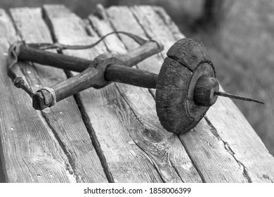 An Ancient Hand Drill On A Wooden Work Bench Outdoors Close Up Black And White