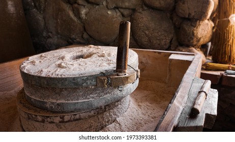 An ancient hand mill made of stones and wood. Flour grinding device. Authentic handicraft - Shutterstock ID 1973393381