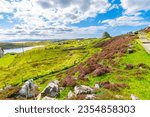 The ancient hilltop ruins of the Dun Carloway Broch roundhouse on a sunny summer day in the district of Carloway, Isle of Lewis, Scotland, United Kingdom.