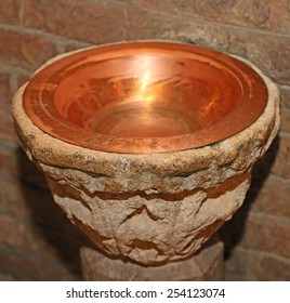 ancient holy water font inside the Church in Italy