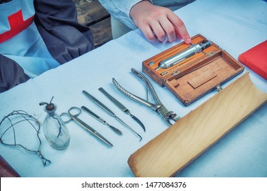 Ancient Hospital For Treatment Soldiers On Battlefield - 18th Or 19th Century. Forceps, Syringe, Scissors, Scalpel And Other Medical Instruments On The Table. Medicine In A Field Military Hospital.