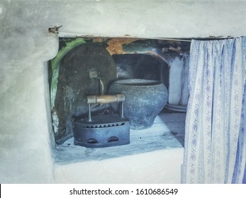  Photo Of Ancient Household Items Of Russia Of The 18th Century, In A Vintage Style. On A Russian Stove With A Curtain There Is A Cast Iron And An Iron.