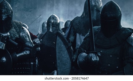 Ancient Invading Army Of Medieval Knights Marching On Battlefield. Plate Body Armored Warriors Walking. War, Battle And Conquest. Epic Cinematic Shot. Professional Historical Reenactment