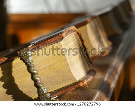 ancient leather bound hymn books inside naturauly lit European church