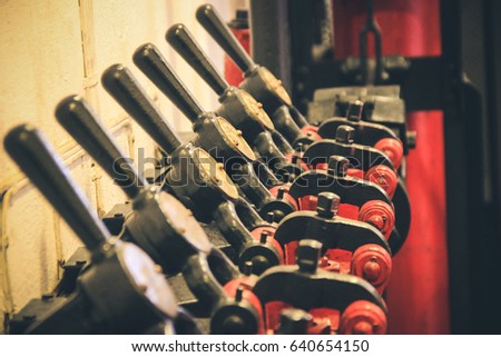 Ancient levers on a control panel machine in a factory