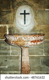 an ancient marble baptismal font in a spanish church