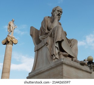 Ancient Marble Statue Of The Greek Philosopher Socrates. Blue Sky And White Clouds On The Background