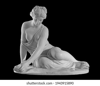 Ancient marble statue of a nude woman. Antique naked female sculpture. Sculpture isolated on black background.