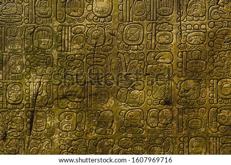 Ancient Maya script carved on the stone wall