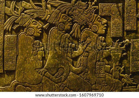 Ancient Mayan drawings carved on the stone wall