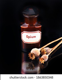 ancient medicine glass with opium and opium capsules