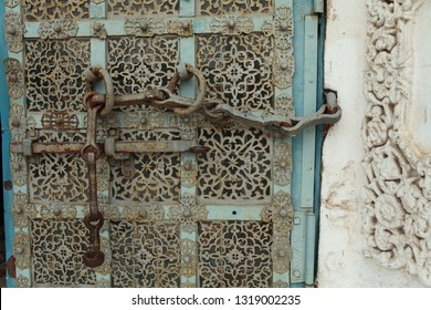 ancient medieva gate with a bolt and chain decorated with rich ornament