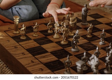 Ancient Metal Roman Chess Set With Silver And Gold Plated Pieces On Solid Oak Wood Board. Concept Image For Business Strategy, Competition, Relaxation, Recreation And Mental Agility.