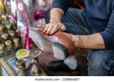 Ancient Method Of Shoe Cleaning With Help Of Shoe Polish. Man Cleans Shoes On Street, Close Up.