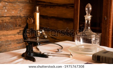 Ancient microscope in an old authentic laboratory. Rural old medical laboratory.