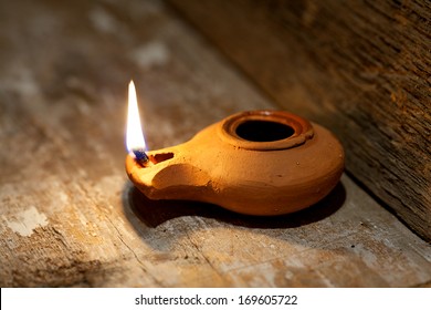 Ancient Middle Eastern Oil Lamp Made In Clay On Wood Table