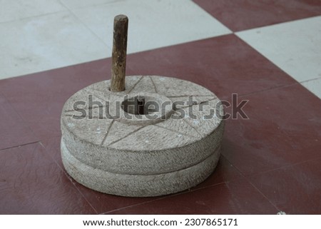The ancient millstone , hand grain mill. Traditional Grinding with stone