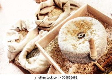 Ancient Millstone With Wheat Grains. Closeup Shot