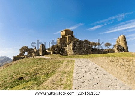 ancient monastery of Jvari in Georgia against the background of a blue sky with clouds