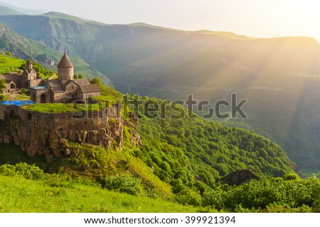 Ancient monastery in setting sun. Tatev. Armenia