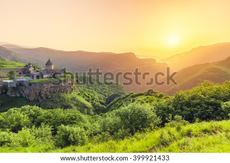 Ancient monastery in setting sun. Tatev. Armenia