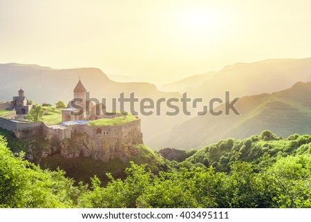 Ancient monastery in setting sun. Tatev. Armenia