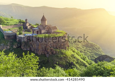 Ancient monastery in setting sun. Tatev. Armenia