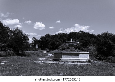 Ancient Monterano, Octagonal Fountain In Ghost Town In The Nature Reserve. A Rural Path In An Old Black And White Atmosphere
That Tells The Story Of The Past
In A Sunny Summer Day In A Historic Place