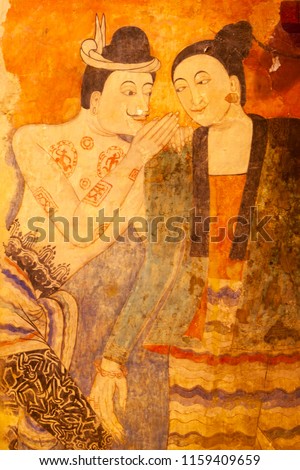 Ancient murals painting of man whispering to woman, famous mural painting at Wat Phumin, a famous buddhist temple in Nan Province, Thailand. The temple is open to the Public.