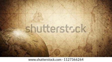 Ancient old globe on the vintage map background. Selective focus. Retro style. Science, education, travel, vintage background. History and geography team.