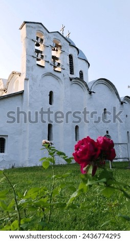 Ancient orthodox christian Cathedral of Ioann Predtecha (John the Precursor) of the Ivanovsky Monastery, 1240. Church located in Pskov, Russia. Russian temple. Unique old architecture. Cross. Red rose