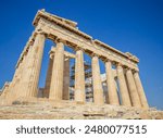 Ancient Parthenon Temple on top of the Acropolis Athens, Greece at sunny day with a blue sky. The landmark of Athens. Parthenon is the temple of for dedication to the goddess Athena. 